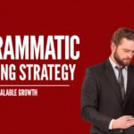 Programmatic Marketing Strategy framework for scalable growth showing marketing professional analyzing data on laptop against red background.
